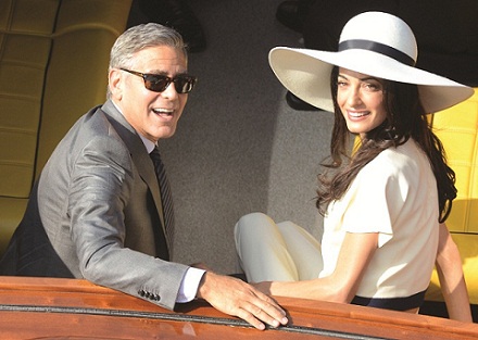 George Clooney and his wife Amal Alamuddin leave the city hall after their civil marriage ceremony in Venice, Italy, Monday, Sept. 29, 2014. George Clooney married human rights lawyer Amal Alamuddin Saturday, the actor's representative said, out of sight of pursuing paparazzi and adoring crowds. (AP Photo/Luigi Costantini) ** Usable by LA, DC, CGT and CCT Only **