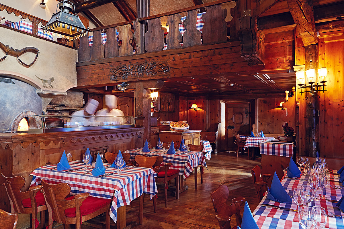 Cozy up with Celebrities at this Rustic Chalet Restaurant in St. Moritz