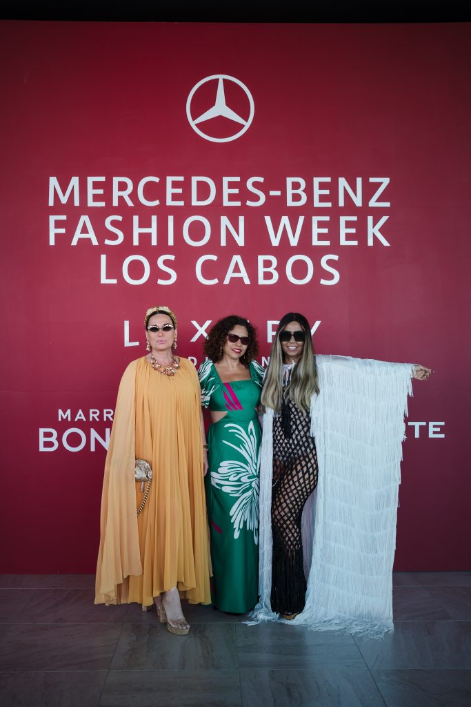 Jazmín Ayarahuan,Sonia Falcone and Angie Carranza in front of banner for MBFW