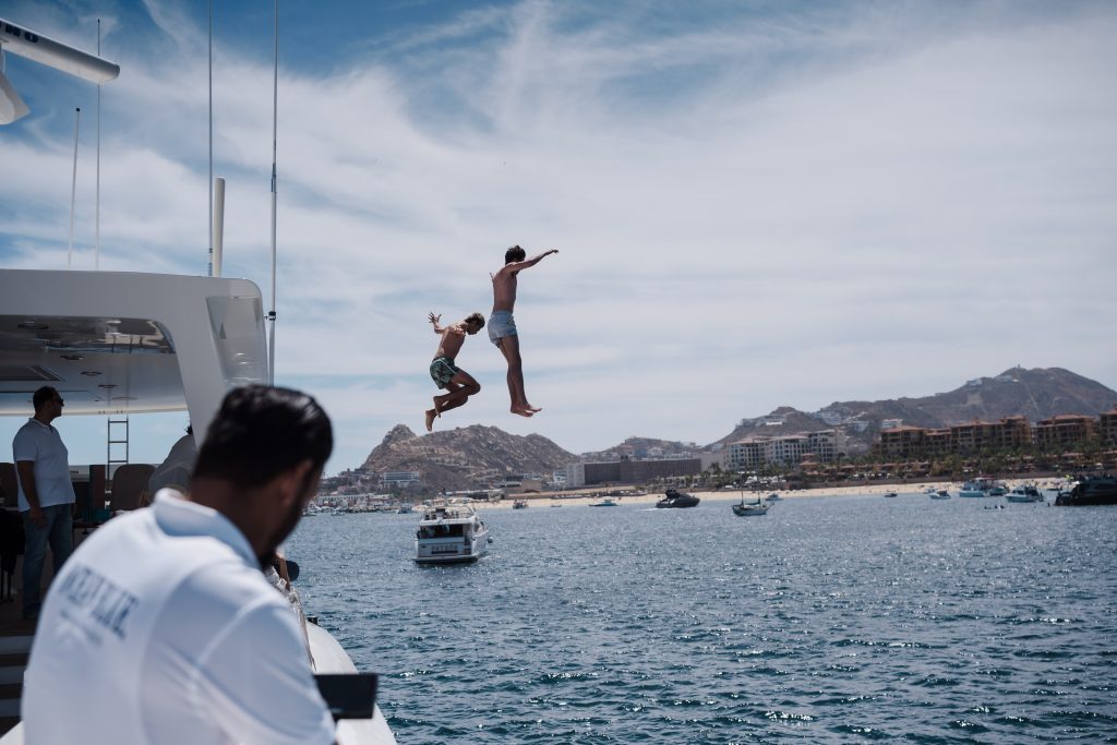 Sebatían and Luca Van Belle jumping off yacht into sea of cortez