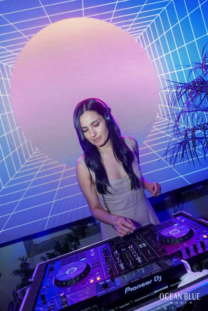 photo of female DJ mixing music for GP RACING NIGHT 2024