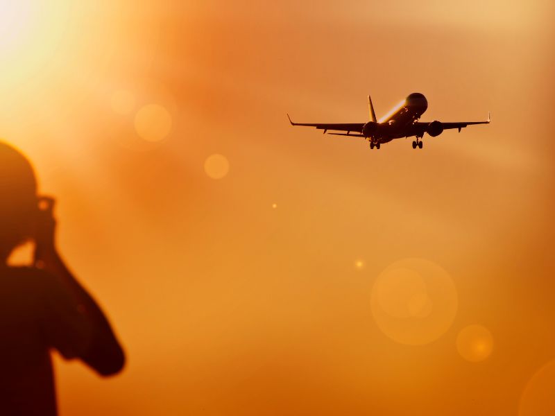 photo of a jet taking off at sunset