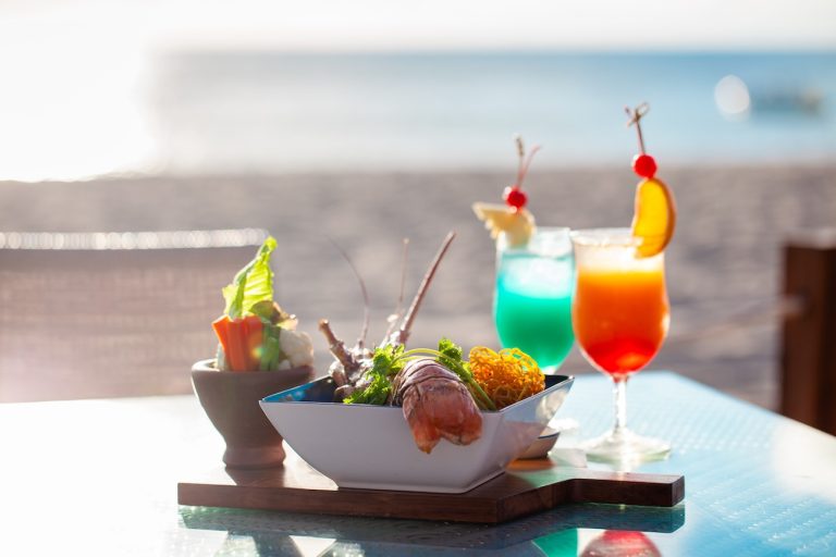 photo of tropical drinks and lobster