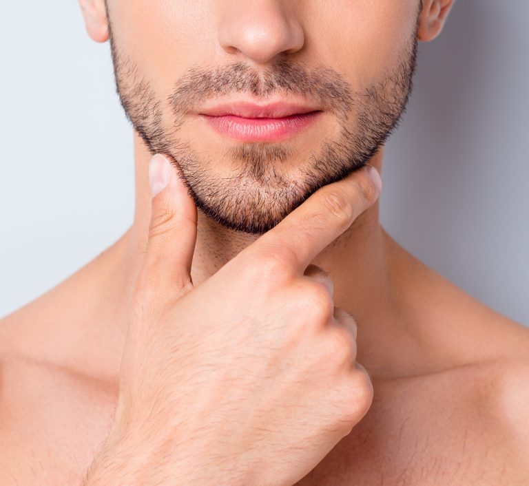 cropped close up of male face with short beard