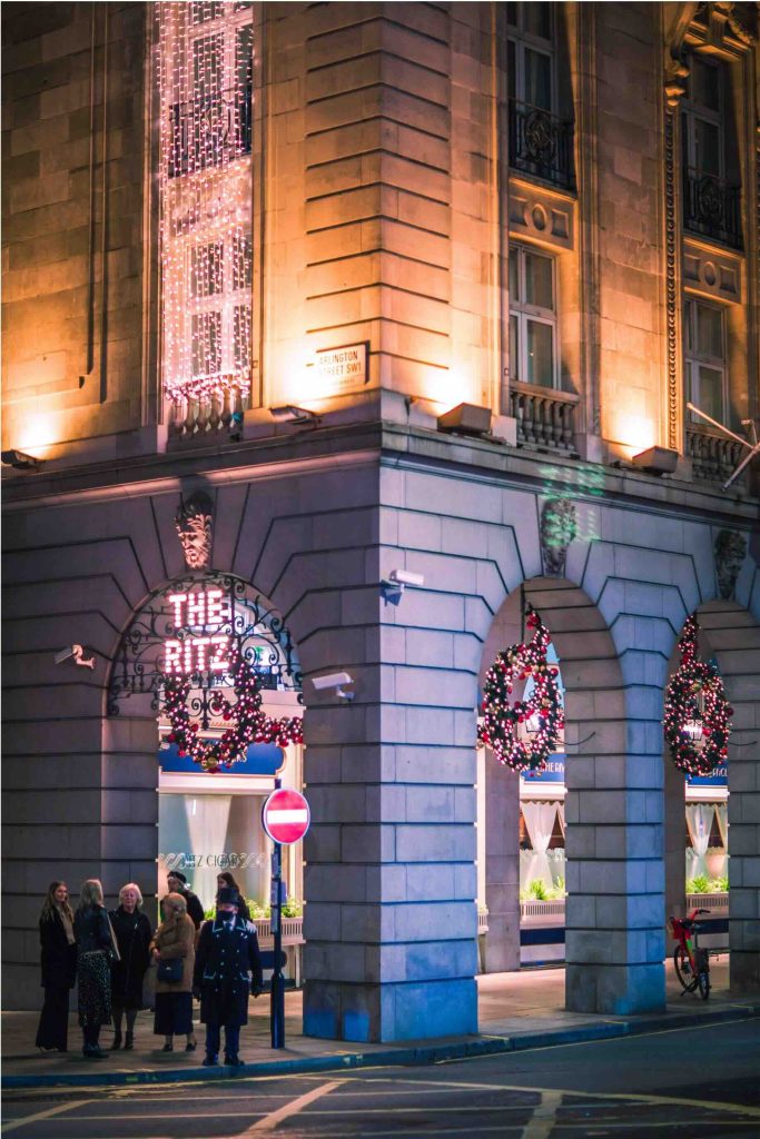 Ritz hotel and people walking on the street. London's night life